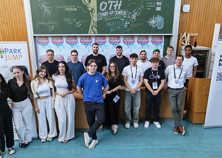 Gruppenbild mit Studierenden und Professor in einem Hörsaal